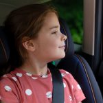 little girl sitting in joie car seat