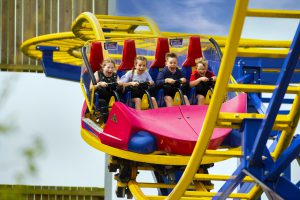 Kids enjoying a roller coaster