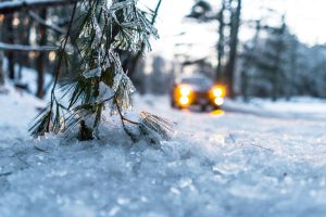 Car headlights shining in a snowy landscape